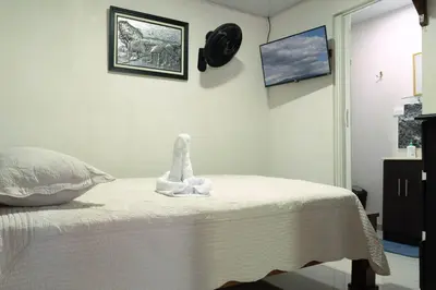 a bedroom with a bed with a stuffed animal on it at Nice private apartment studio to discover CR in Alajuela City