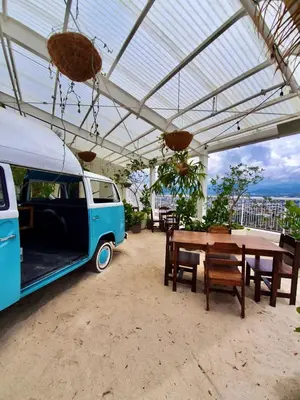 a van parked under a tent with a table and chairs at Cómodo y elegante apartamento en fabuloso condo! in San José