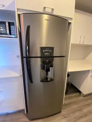 a stainless steel refrigerator with a coffee maker at Cómodo y elegante apartamento en fabuloso condo! in San José