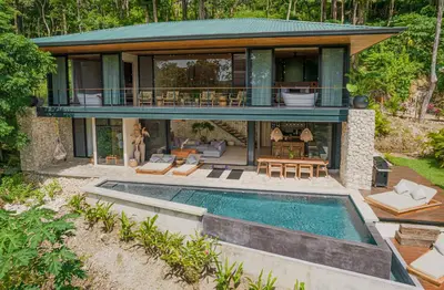 a house with a swimming pool in front of it at Villa Lasai - Brand New Villa Luxury Villa in Carmen