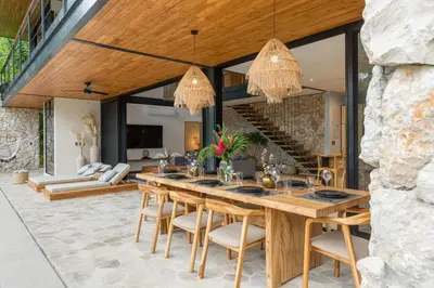 a dining room with a large wooden table and chairs at Villa Lasai - Brand New Villa Luxury Villa in Carmen