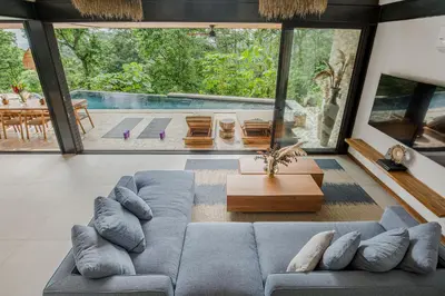a living room with a couch and a table at Villa Lasai - Brand New Villa Luxury Villa in Carmen