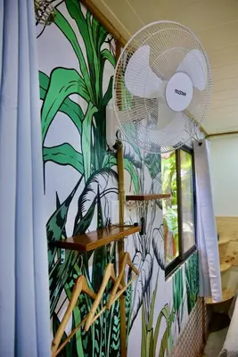 a wall with a mural of a plant at TERMINAL VERDE PRIVATE APARTMENTS NEAR AIRPORT 24h SELF CHECK IN in Concepción