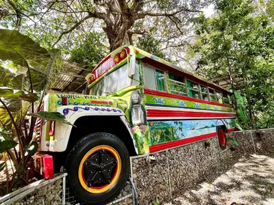a colorful bus is parked next to a fence at TERMINAL VERDE PRIVATE APARTMENTS NEAR AIRPORT 24h SELF CHECK IN in Concepción