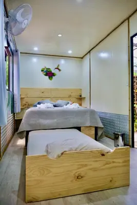a bedroom with a bed with a wooden bed frame at TERMINAL VERDE PRIVATE APARTMENTS NEAR AIRPORT 24h SELF CHECK IN in Concepción