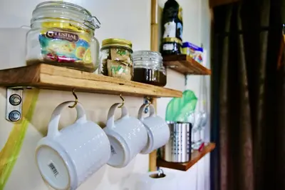 a group of white coffee cups hanging on a wall at TERMINAL VERDE PRIVATE APARTMENTS NEAR AIRPORT 24h SELF CHECK IN in Concepción
