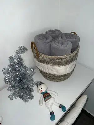 a table with a christmas tree next to a basket at Lapa Lodge G1 in Jacó