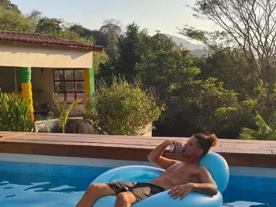 a man laying on an inner tube in a swimming pool at La Casa del Conde in Playa Naranjo