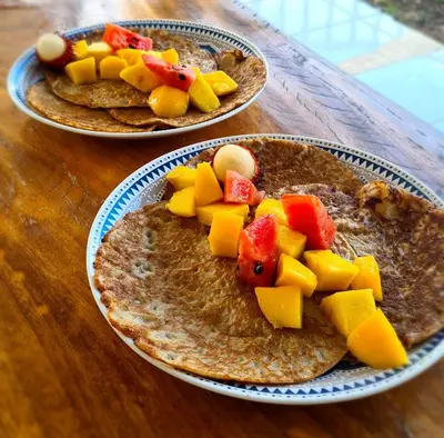 two plates of food with fruit on them on a table at La Casa del Conde in Playa Naranjo