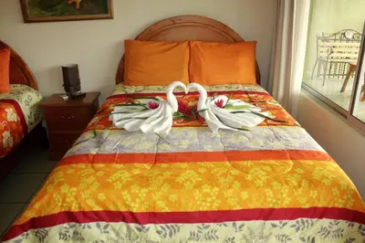 two swans are sitting on a bed in a bedroom at Hotel FAS in Fortuna