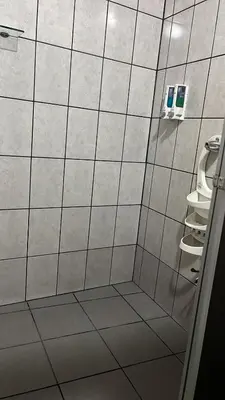 a bathroom with a shower with white tiled walls at Hotel FAS in Fortuna
