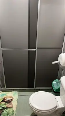 a bathroom with a toilet and a shower stall at Hotel FAS in Fortuna