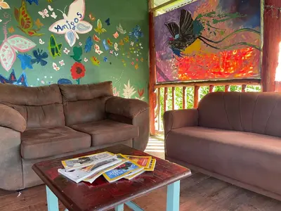 a living room with two couches and a coffee table at Centro Ecológico Montaña Verde in Rivas