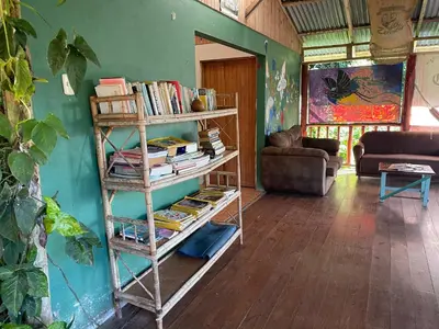 a room with a book shelf filled with books at Centro Ecológico Montaña Verde in Rivas