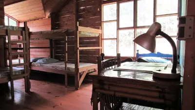 a room with bunk beds and a desk with a lamp at Centro Ecológico Montaña Verde in Rivas