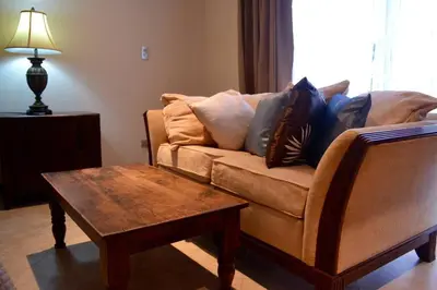 a living room with a couch and a coffee table at Beach Front Boutique Condominium in Jacó
