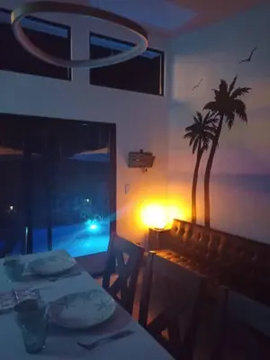a dining room with a table and a palm tree at Loft 45 in Playa Hermosa, paradise near the ocean! in Playa Hermosa