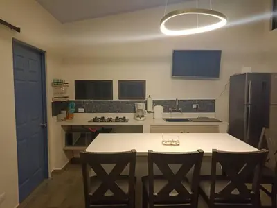 a kitchen with a table and two chairs and a refrigerator at Loft 45 in Playa Hermosa, paradise near the ocean! in Playa Hermosa
