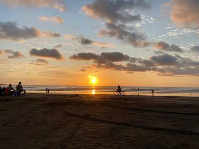 a person riding a bike on the beach at sunset at Loft 45 in Playa Hermosa, paradise near the ocean! in Playa Hermosa