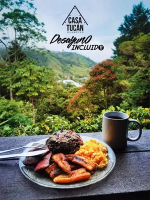 a plate of breakfast food and a cup of coffee at Casa Tucan Glamping in Turrialba