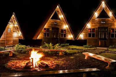a fire pit in front of a building at night at Casa Tucan Glamping in Turrialba