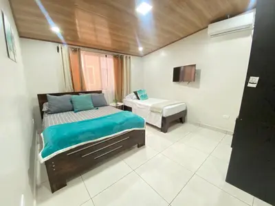 a bedroom with a bed and a sink in it at Apartamento H Gonzalez 14 free Parking AC wifi in Alajuela City