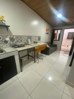a kitchen and living room with a table and a stove at Apartamento H Gonzalez 14 free Parking AC wifi in Alajuela City