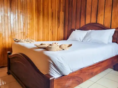 a bed with hats on top of it at CASA ISAMAR in Monteverde Costa Rica