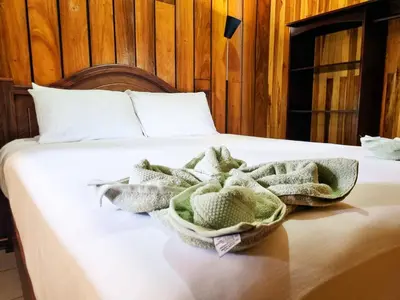 a bed with towels on top of it at CASA ISAMAR in Monteverde Costa Rica