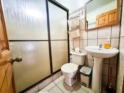 a small bathroom with a toilet and a sink at CASA ISAMAR in Monteverde Costa Rica
