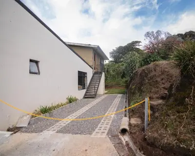 a building with a staircase next to a house at CASA ISAMAR in Monteverde Costa Rica
