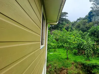a side view of a house with a window at CASA ISAMAR in Monteverde Costa Rica