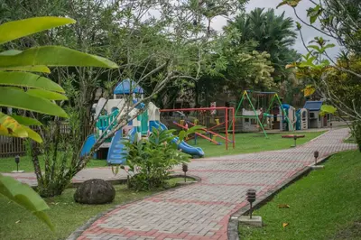 a park with a playground with a slide at Hotel Suerre in Guápiles