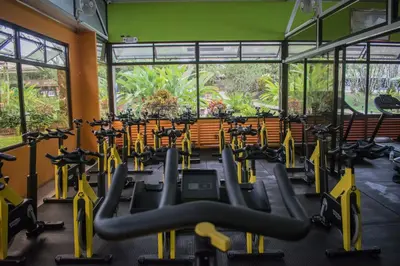 a gym with rows of treadmills and exercise bikes at Hotel Suerre in Guápiles