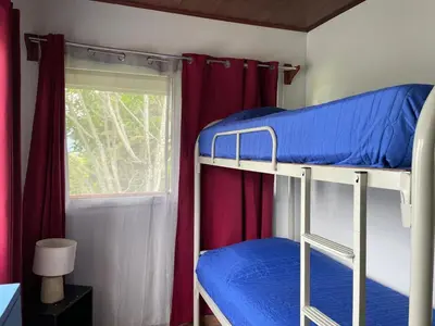 two bunk beds in a room with a window at El Ensueño in Ujarrás