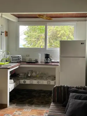 a kitchen with a white refrigerator and a window at El Ensueño in Ujarrás