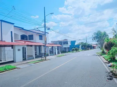 an empty street in a town with houses at Don Carlos Place UPPER UNIT in Alajuela City