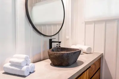 a bathroom with a bowl sink and a mirror at Blue Mist Hotel- Adults Only in Santa Teresa Beach