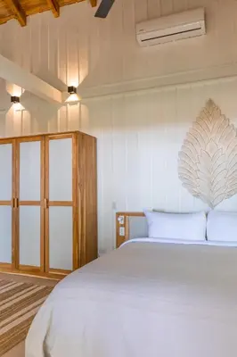 a bedroom with a large white bed with white sheets at Blue Mist Hotel- Adults Only in Santa Teresa Beach