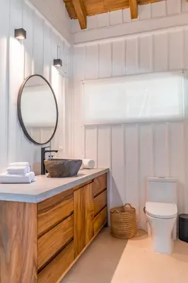 a bathroom with a sink and a mirror and a toilet at Blue Mist Hotel- Adults Only in Santa Teresa Beach