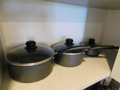 three pots sitting on top of a stove at Sunset 205, sleeps six, next door to the pool, 100m to the beach! in Jacó