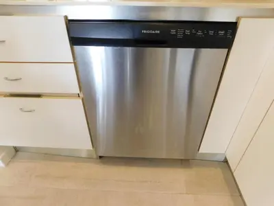 a dishwasher in a kitchen with white cabinets at Sunset 205, sleeps six, next door to the pool, 100m to the beach! in Jacó