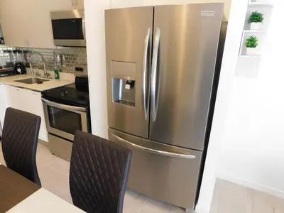 a stainless steel refrigerator in a kitchen at Sunset 205, sleeps six, next door to the pool, 100m to the beach! in Jacó