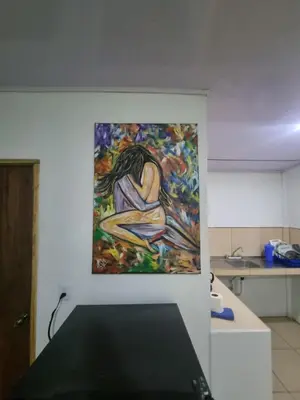 a painting of a woman hanging on a wall at Ballena Oasis Homes( Dep Estudio con AC) in Uvita