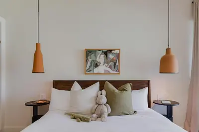 a stuffed teddy bear sitting on top of a bed at Sendero Hotel in Nosara
