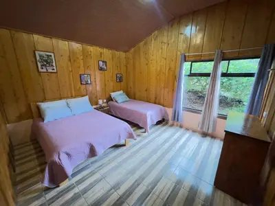 a bedroom with two beds and a window at Eco Finca Tucan in Monteverde Costa Rica