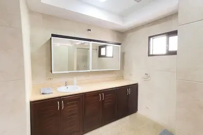 a bathroom with a sink and a mirror at XIN Bed&Breakfast in San José