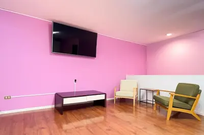 a room with a purple wall with two chairs and a table at XIN Bed&Breakfast in San José