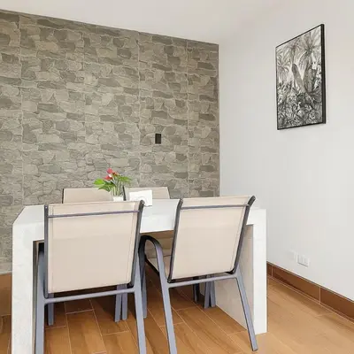 a dining room with a white table and two chairs at XIN Bed&Breakfast in San José