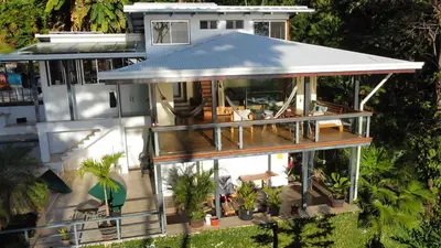 an aerial view of a house with a porch at Jungle Villa copa de árbol, oceanview, infinity in Montezuma